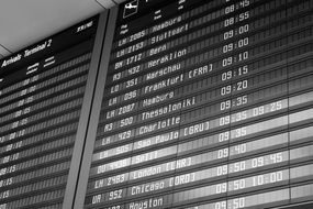 black and white photo of the terminal with a flight schedule