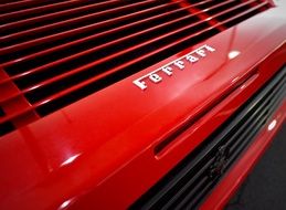 Ferrari logo on a red car close-up