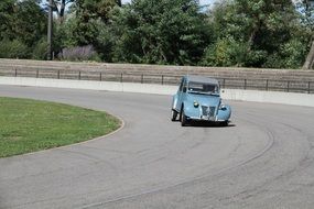 Landscape with the retro blue car on the road