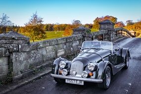 Landscape with the beautiful antique car on the bridge