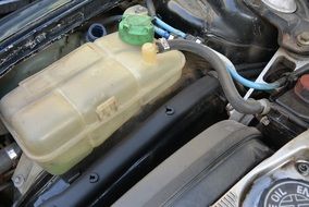 expansion tank under the hood of a car