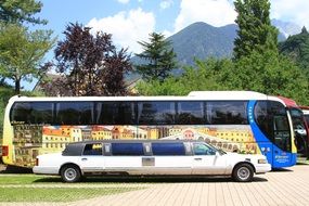 Landscape with the colorful bus and limousine