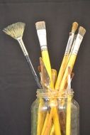 painting brushes in the glass jar