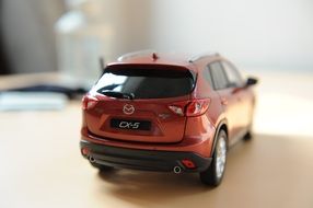 scale model of red Mazda cx-5 under the light