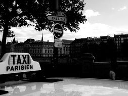 lack and white photo of a taxi in Paris