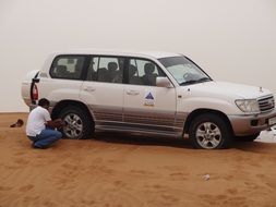 A man near a car in the desert