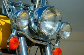 three round front headlights of a retro motorcycle