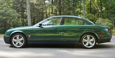 green Jaguar on the road