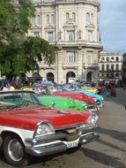 Vintage cars of different colors in the parking lot