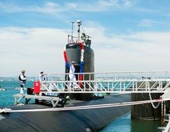 military men on a submarine on a sunny day