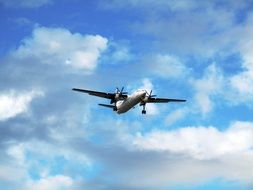 Airplane in the blue sky with the white clouds