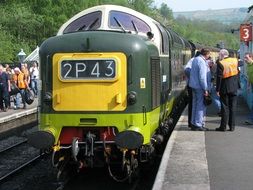 green diesel british train at the station