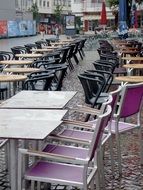 panoramic view of a street cafe with empty chairs