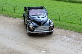 Black car Morris minor on the road