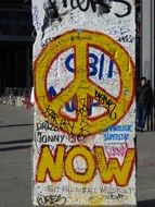 painted peace symbol on a pillar in Berlin