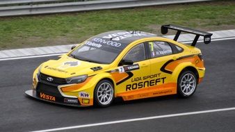yellow race car at the FIA WTCR championship