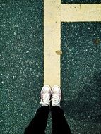 feet on the yellow line on the road