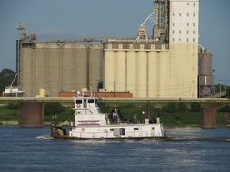 Tugboat on the water on the landscape
