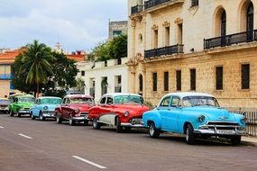 Cars stand on the side of the road in a cuba