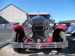 red vintage car with round headlights