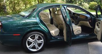 green auto jaguar with open doors