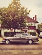 parked vintage car near the house