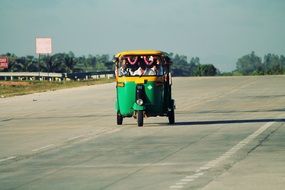 auto rickshaw on the highway on a sunny day