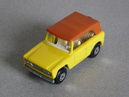 miniature model of a yellow car