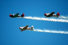 three airplanes in the sky at an aero show