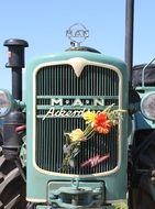 Flowers on the front of an old tractor