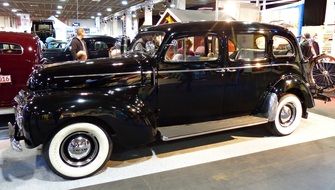 black classic car as an exhibit at the exhibition