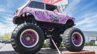picture of the high wheeled auto with hello kitty paintings on it