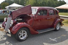 red Classic Car with open hood on Show