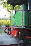 A couple near vintage steam locomotive on the railway