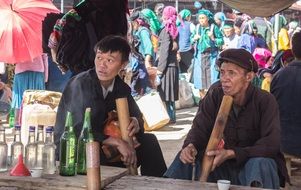 locals with alcohol at a market in vietnam