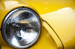 Beautiful yellow retro car with the headlight