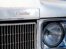 front of a silver Cadillac close-up