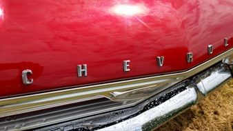 red retro chevrolet under the bright sun close up