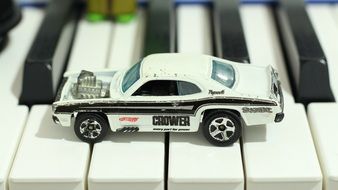 toy racing car on the piano