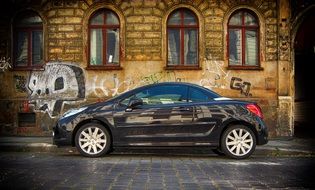black car stands in an old building
