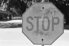 black and white photo of a stop road sign