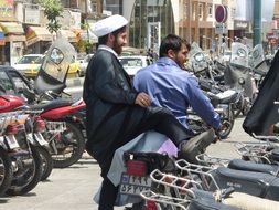 A man sits on a moped