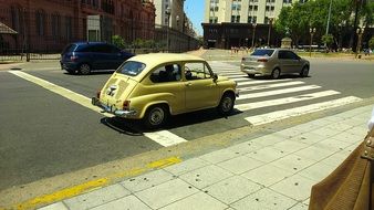 yellow retro car rides along the street