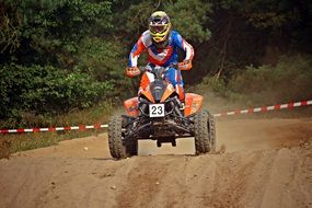 Athlete on an ATV on the sandy road