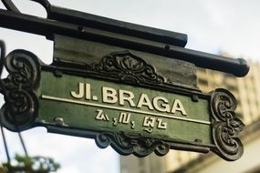 road sign with the name of the street on the wall close-up on blurred background