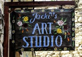 wooden signboard with the inscription "art studio"