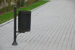 metal urn on a trail in a park