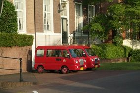 Red vehicle stand on the road