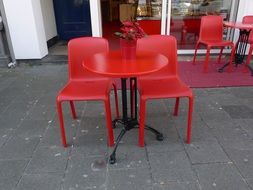 picture of the red chairs and tables in a cafe