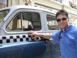 tourist near a vintage car at an exhibition